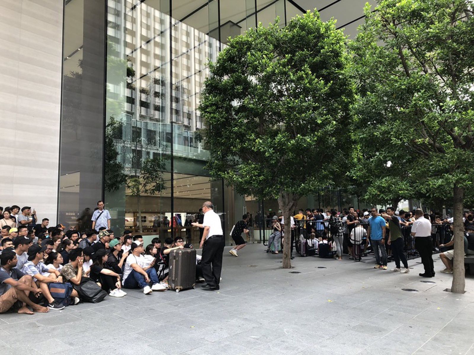 Individuals stand in line for the release of the new iPhone 11 at